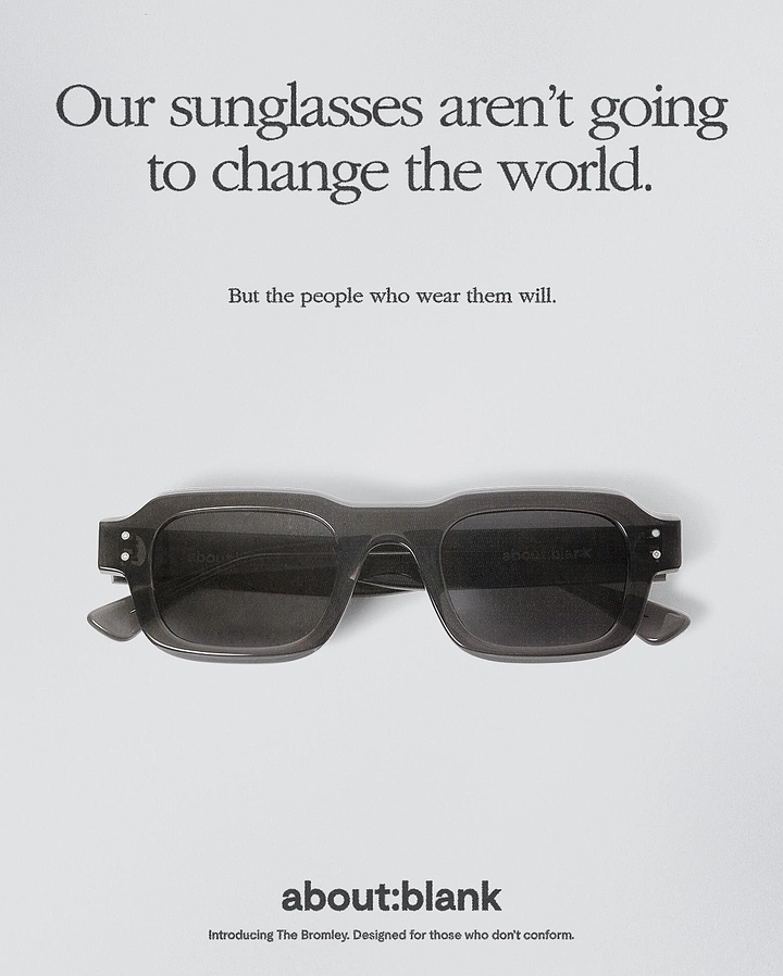 Creative ad: Folded grey translucent sunglasses on pale grey