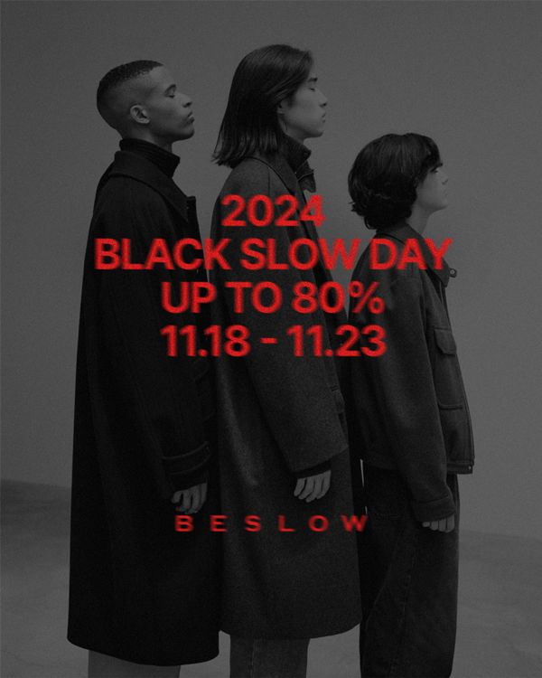 Three models in dark coats standing in profile