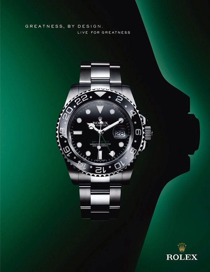 Creative ad: Steel GMT wristwatch with a black bezel, shown face-on