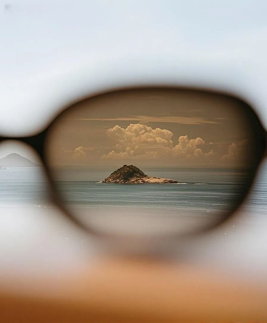 Instagram post: Island landscape framed through sunglasses
