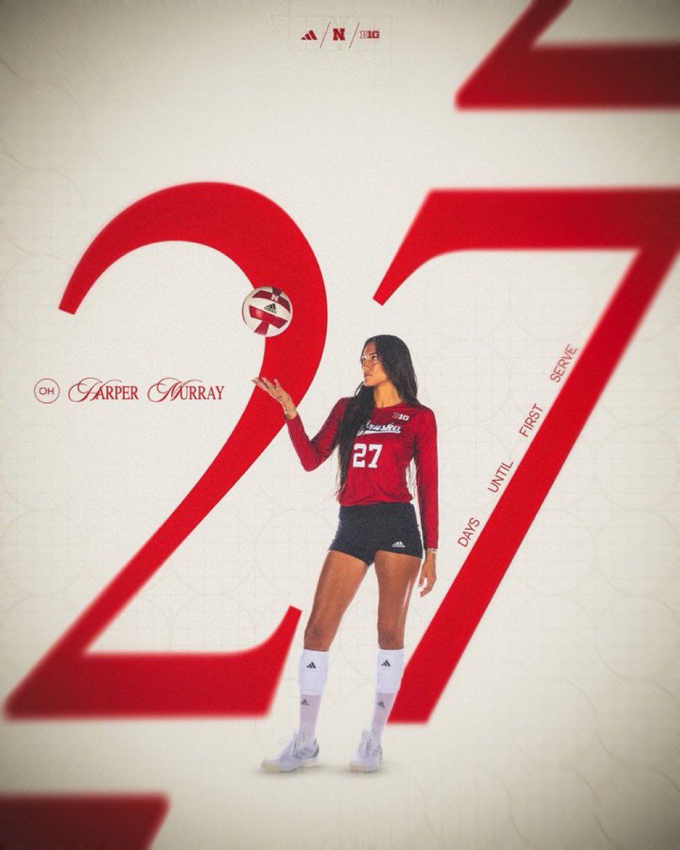 Volleyball player tossing ball in front of giant red 27